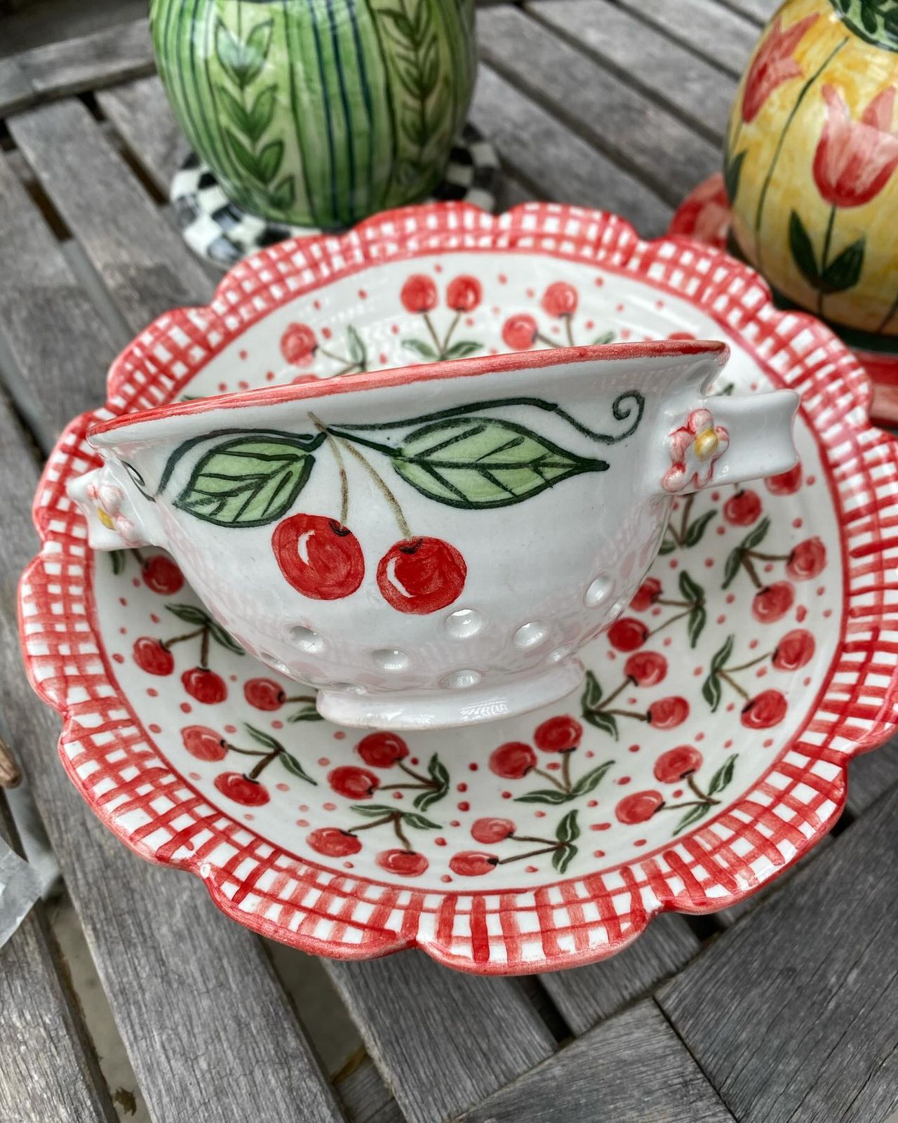 Cherry colander on a scalloped plate